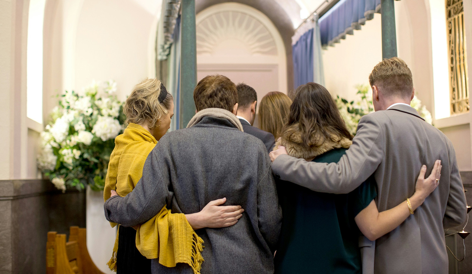 Loved ones paying tribute during a personalised funeral ceremony